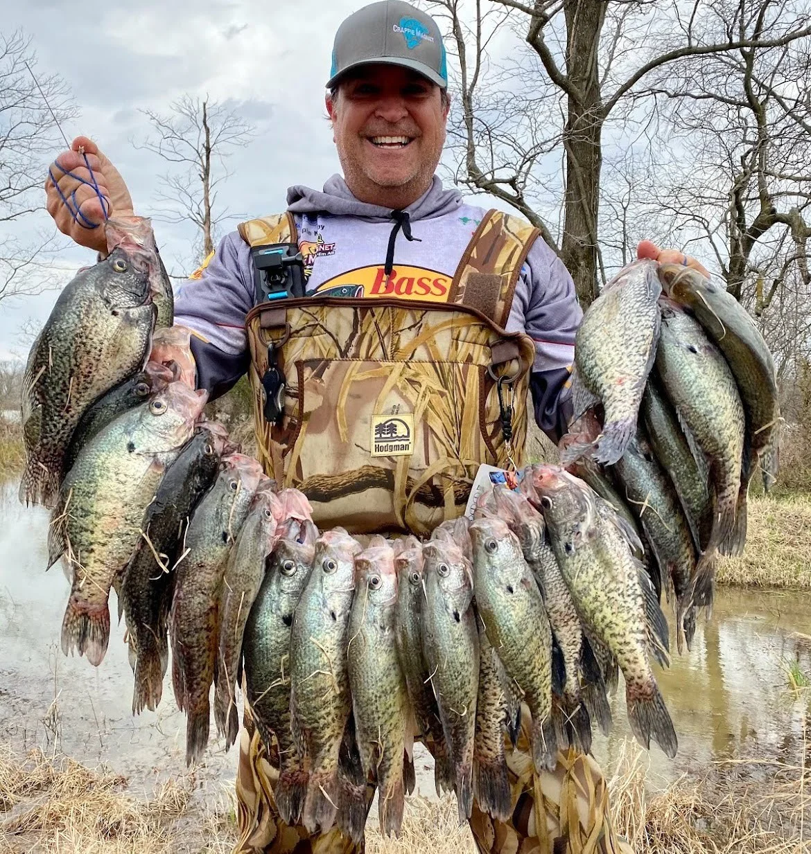 Fisherman proudly holding large catch of fish